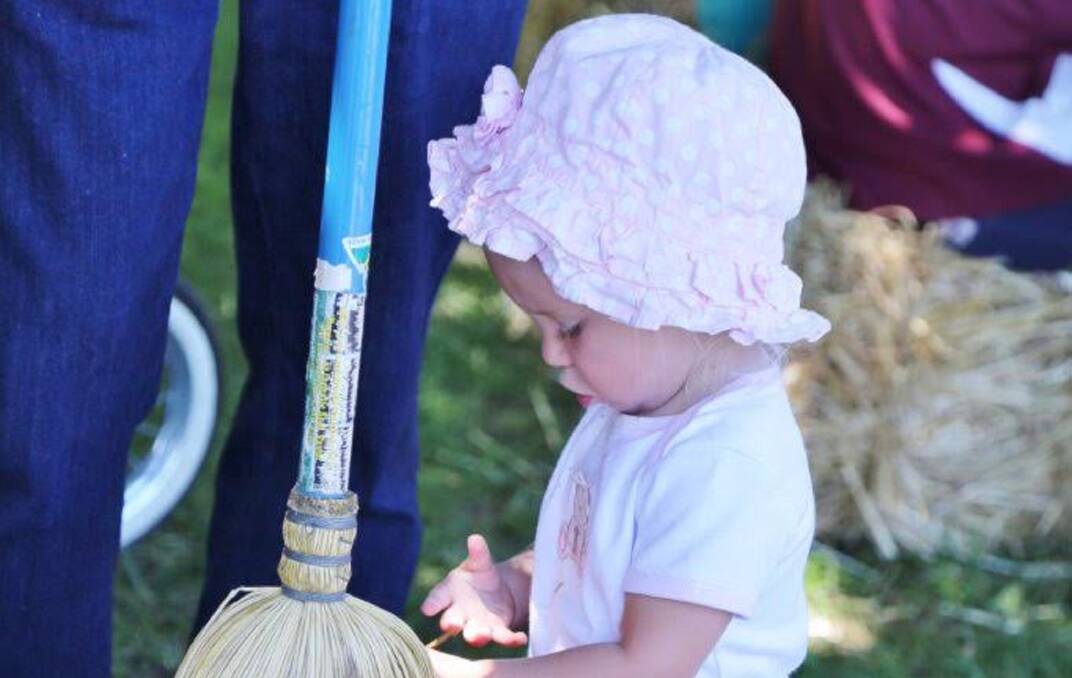 HANDS DIRTY: This little one is enjoying the pets and sheep exhibits. Good to get 'hands on' experience.