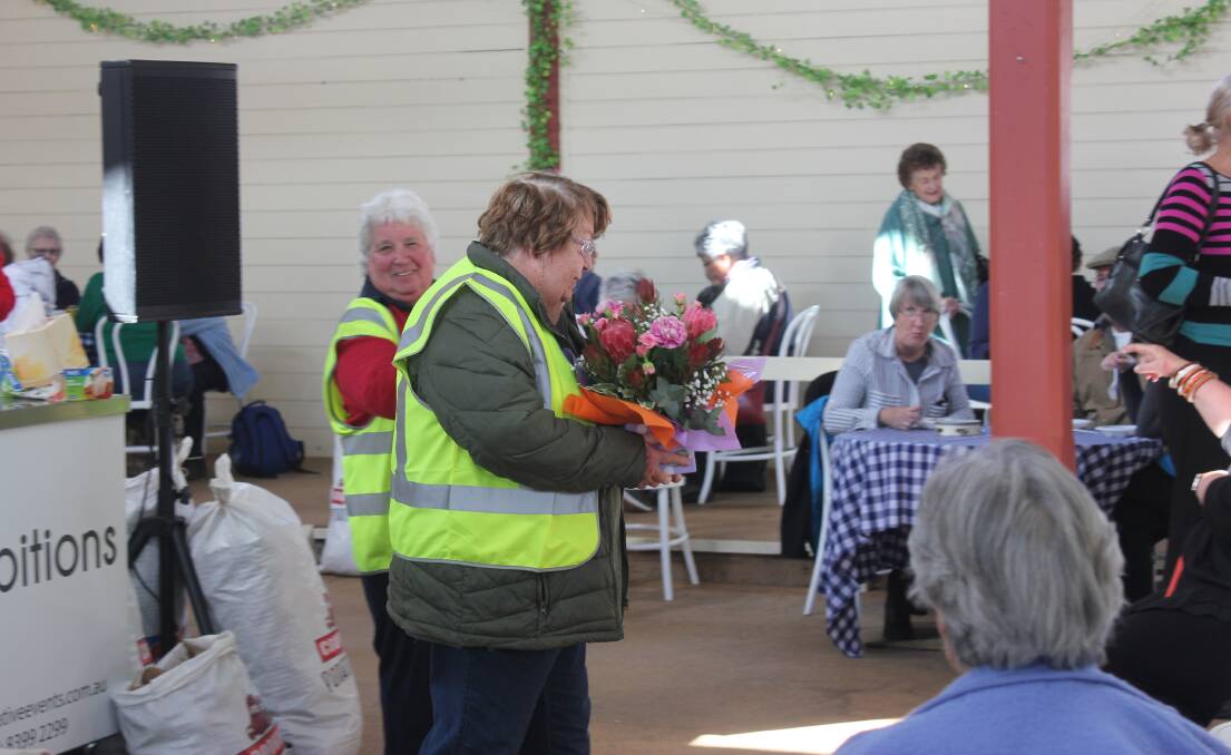 DEDICATION: Crookwell Potato Festival chair Joyce Edwards  receives flowers for her hard work over the festival weekend. Photo: Mariam Koslay