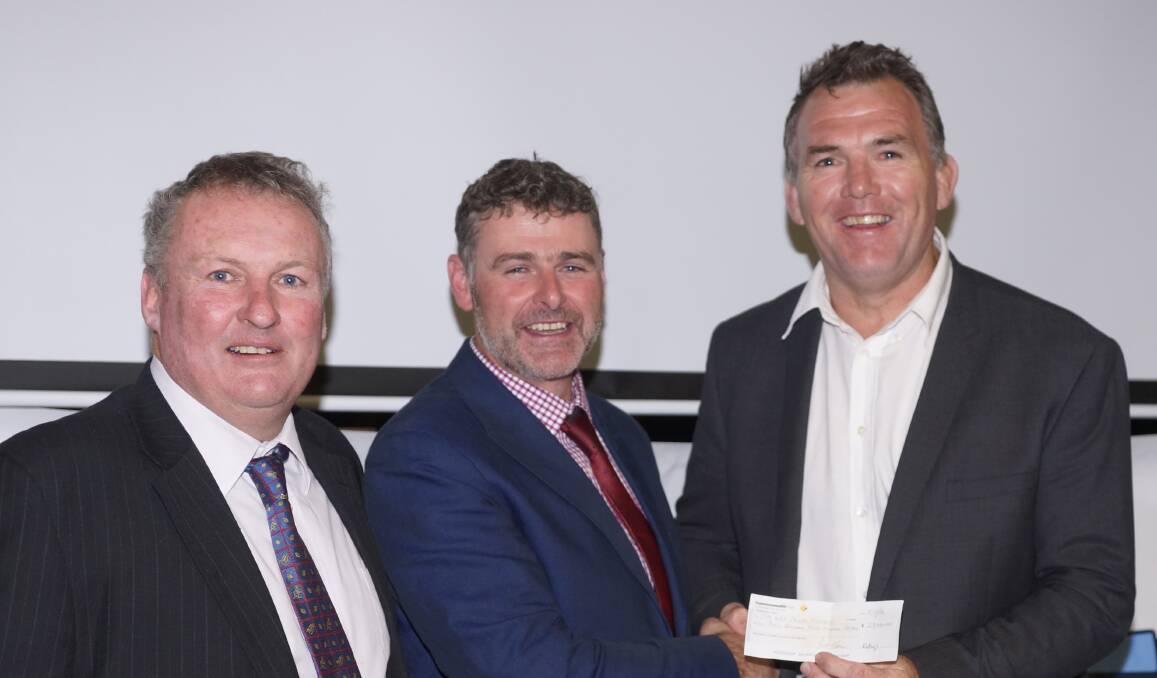 Money back: Rugby representatives Chris Croker and Michael Lowe with Owen Finegan, who donated his fee to the Kids Cancer Project.