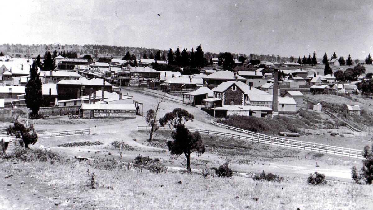 The last building on the right side of the photograph is Cox Bros Flour Mill. Next door, on the left of the Mill, the building with the extended verandah was used as a Post Office.

