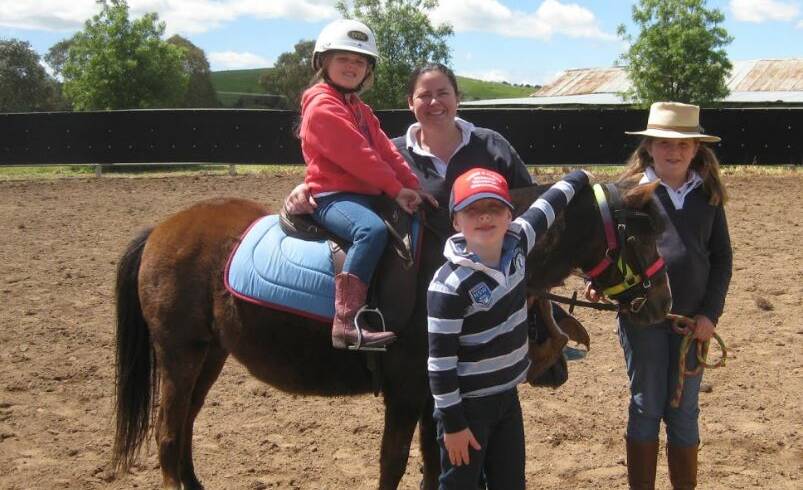 POLOCROSSE: Skye Yeo, 6, on Blaze with mother Katie Yeo and friends from Yass, Olivia McColl, 9, and Cooper Downey, 5, at the Yass Polocrosse event.