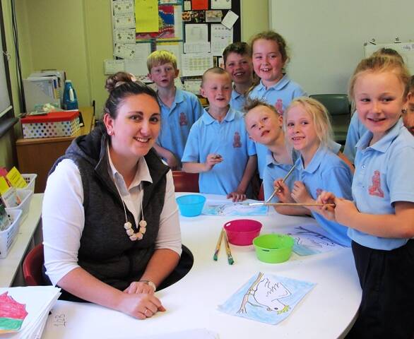 TEACHER: A very popular Miss Kaisee O’Keefe surrounded by students in Year 1/2 during an art lesson.
