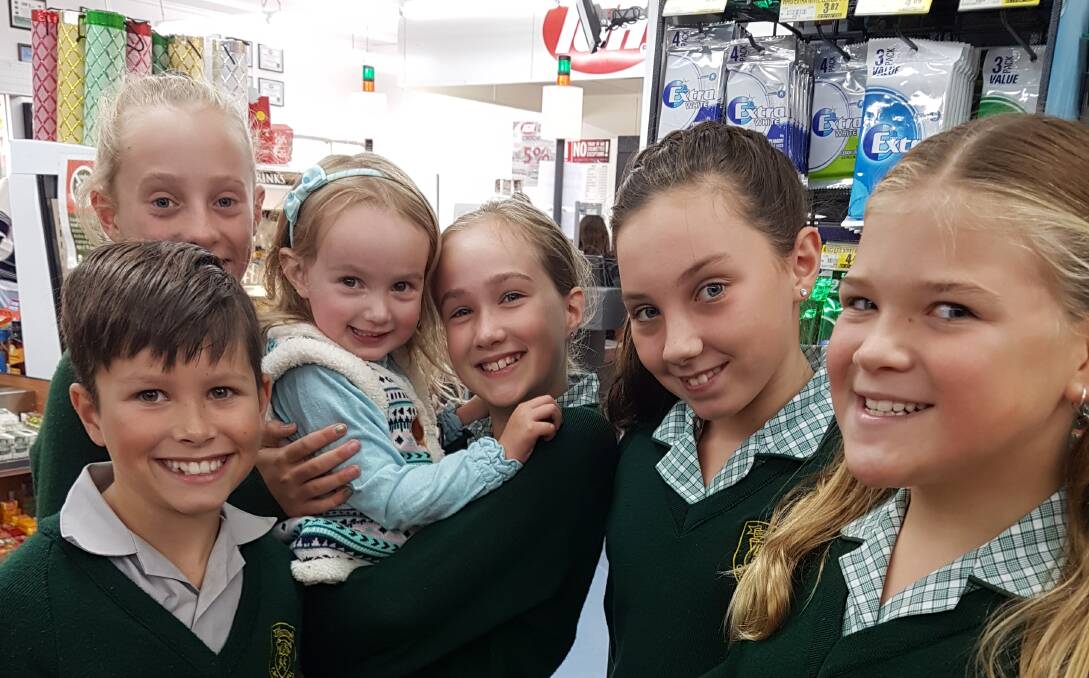HELPING HANDS: During Catholic Schools Week Year Five ably assisted shoppers at the IGA Supermarket.