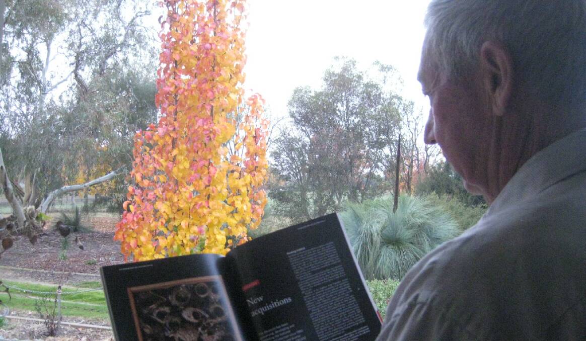 FAMILY: John Weatherstone peruses an article about his father Gladstone Weatherstone's Collection, recently acquired by the National Museum of Australia.