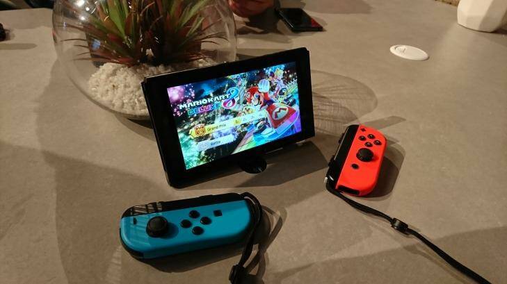 With the extra bulk of the strap attachment, the Joy-Con become small but usable controllers for two-player games.  Photo: Tim Biggs