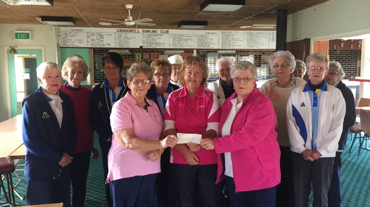 In pink is Leona Evans from the Crookwell Community Trust accepting the cheque from bowling representatives also in pink, Colleen Picker and Joy Stephenson.