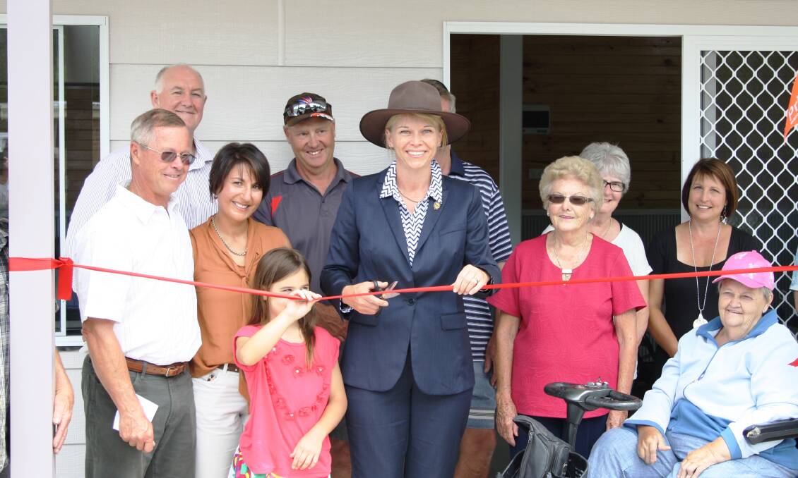 Katrina Hodgkinson (centre), Member for Burrinjuck cuts the ribbon to officially open the new cooking facility at Crookwell Caravan Park. Assisting Katrina were (L to R): Mayor John Shaw; Council General Manager, John Bell; Lucy Marshall; Council's Media Officer, Maria Vassallo; Council's Parks and Gardens Maintenance Officer, John Hanley; Council's Outdoor Works Supervisor, Mick Jones; local residents and Clr Jo Marshall. Photo by Maria Vassallo.
