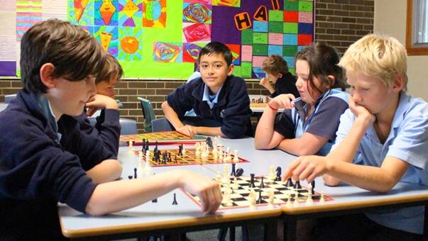 Chess Club: Crookwell Public School chess team members are vigorously honing their strategic thinking skills as they prepare for an upcoming chess tournament. They will be facing off against Goulburn East PS and Yass PS. Although anxious to play, CPS chess team members are quietly confident of a positive outcome! Ari Stephenson, Sam McGregor, Rueben, Mackenzie Gauci and
Oliver Gray focus on strategy during a chess training session after school.