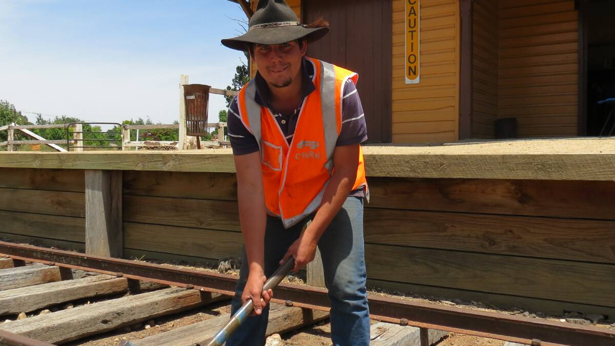 GCHR volunteer, Lenny Stewart, hammers gold pegs to celebrate completion of track work