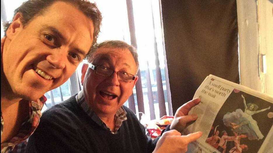 Happy faces from Jeremy Secomb (left) and friend as they read the London Telegraph’s report of his appointment to the major role of Inspector Javert in “Les Miserable.” 