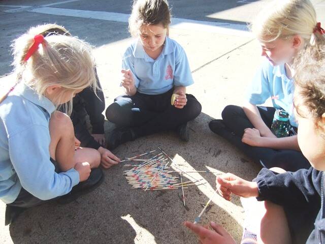 Games from the Past: Girls in Stage 1 patiently try their hand at ‘pick-up sticks. Students in Stage 1 have enjoyed learning about the past. We have recently had a “Games from the Past Afternoon”. Students participated in quoits, hoola hoops, marbles, skipping, pick up sticks, elastics and hopscotch. Students enjoyed reliving these games and recognised how these games are similar to what we play today.