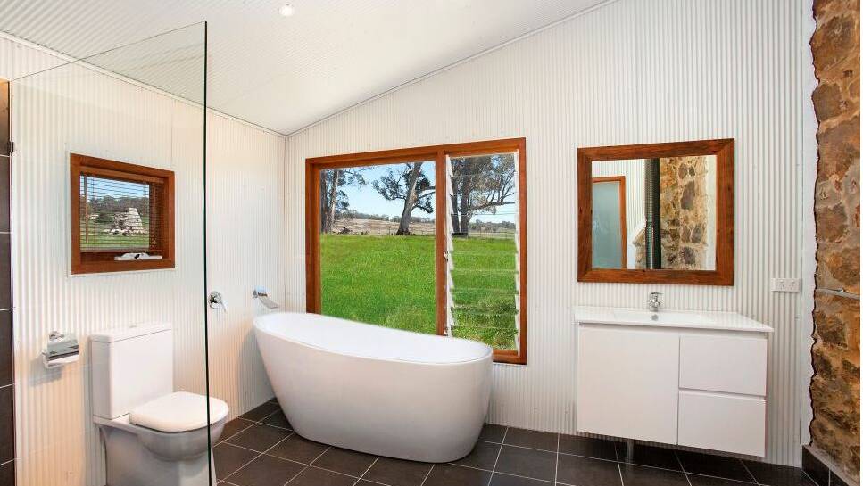 Luxury in the bathroom with a large free-standing bath with rural views