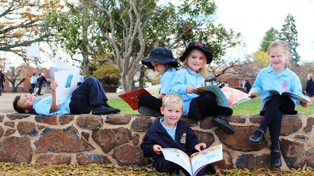  Haka Hape, Lily Hattam, Mia Butler, Ada Dunn and Lincoln Kearney found the new stone wall to be a beautiful spot to sit and enjoy a good book.
You may have noticed while driving along the Colyer St end of school recently that Graham McCarten has been very busy constructing a new entry and stone wall. This new entry has been constructed to match the entries on the Denison St side of the school. The new entry and wall is part of our exterior beautification plan to improve the look and feel of the grounds to enhance learning and a sense of wellbeing. The wall is perfect for mums and dads to sit on and chat in the sun while waiting for their children to finish school for the day and is also a great place to relax and read your favourite book as some of our Kindergarten students found out this week. Thank you to Graham for his amazing stone masonry skills.