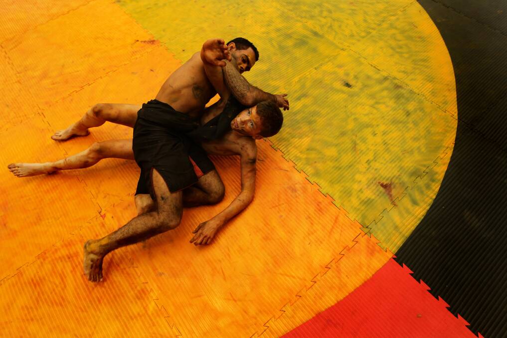 Shane Parker (left) and Blaike O'Neill demonstrate the traditional aboriginal wrestling called Coreeda during NAIDOC celebrations at Emerton Leisure Center in Sydney. Photo: Kate Geraghty 