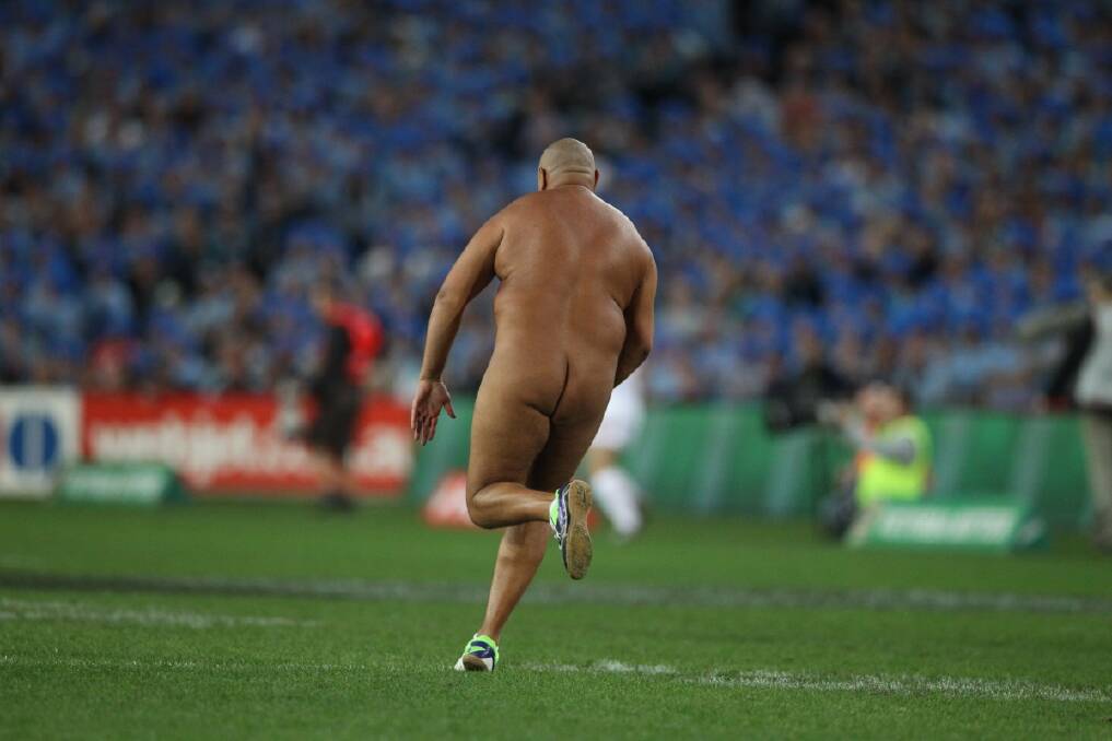 A streaker invades the pitch during the final games of the 2013 State of Origin series 2013 at ANZ Stadium in Sydney.Photo: Anthony Johnson 