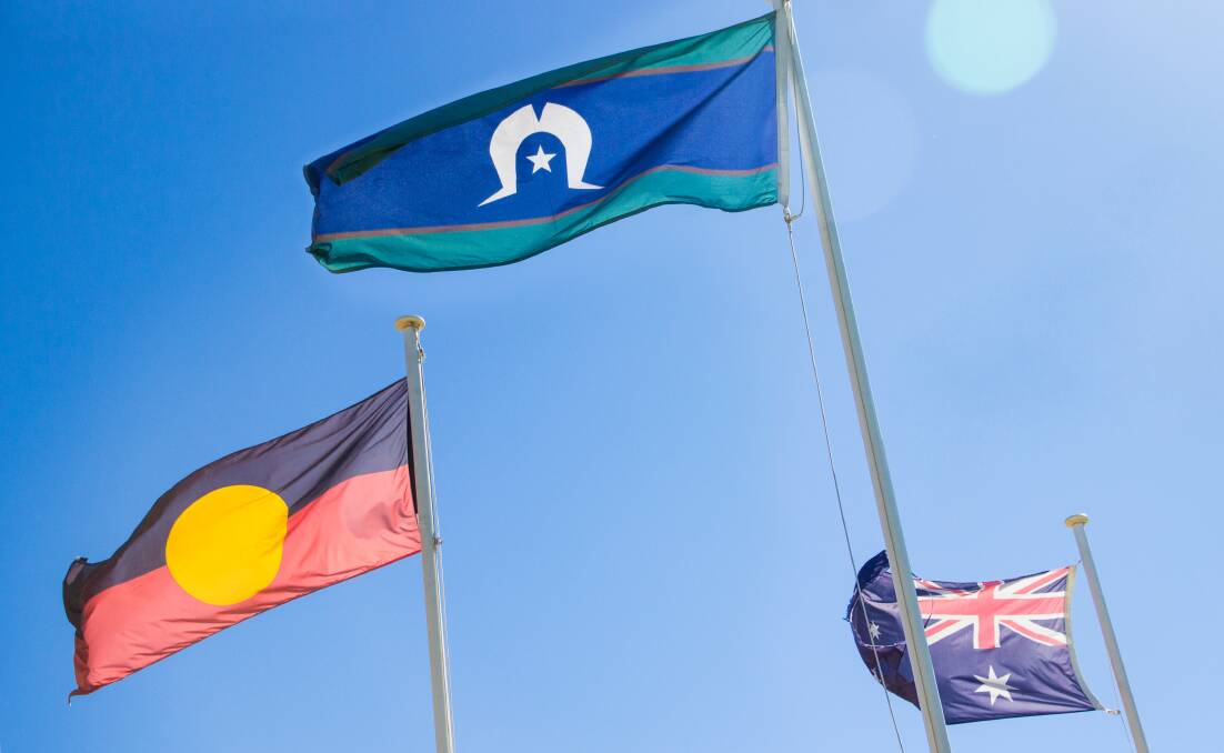 The Australian Aboriginal Flag, the Torres Strait Islander Flag and the Australian Naional Flag. Photo: Shutterstock 