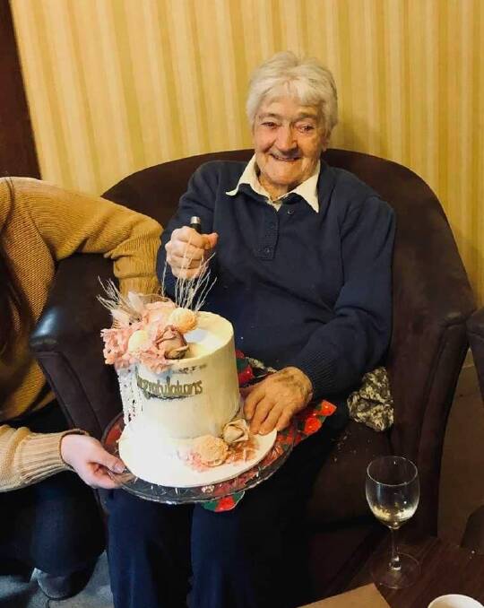 OAM recipient: Helen Campbell cutting her celebratory cake. Photo: Robert Bill.