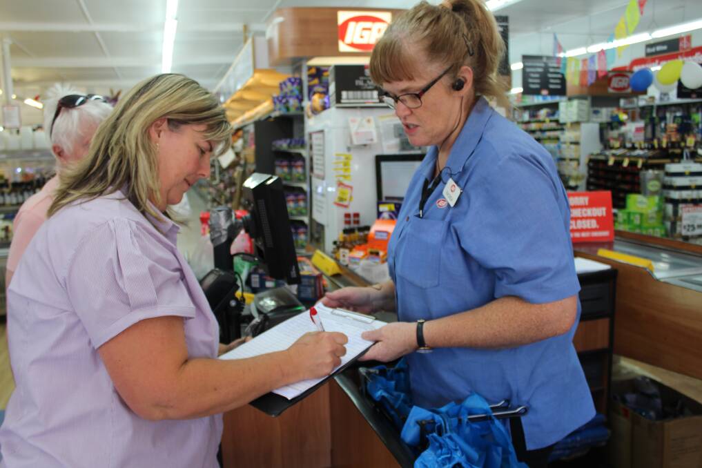 Crookwell IGA staff member speaks to a cutomers about the petition on Thursday afternoon. 