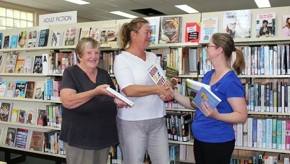 Crookwell CWA Evening Branch Secretary Jenny Painter and Treasurer Jackie Blowes present Council’s Manager, Library Services, Michaela Olde with the new books. Photo: supplied. 