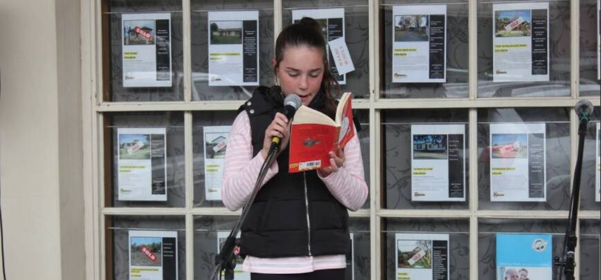 2017 Crookwell Potato Festival Poetry entrant reading on the main street. 