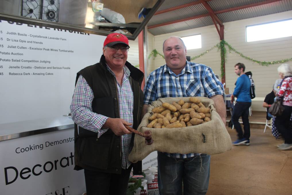GOLDEN HARVEST: The first box of Crookwell's Gold potatoes were auctioned for $1,000 at the annual Crookwell Potato Festival. Half of the proceeds will go towards the Upper Lachlan Shire Trust, and return into the community. Photo: Mariam Koslay. 