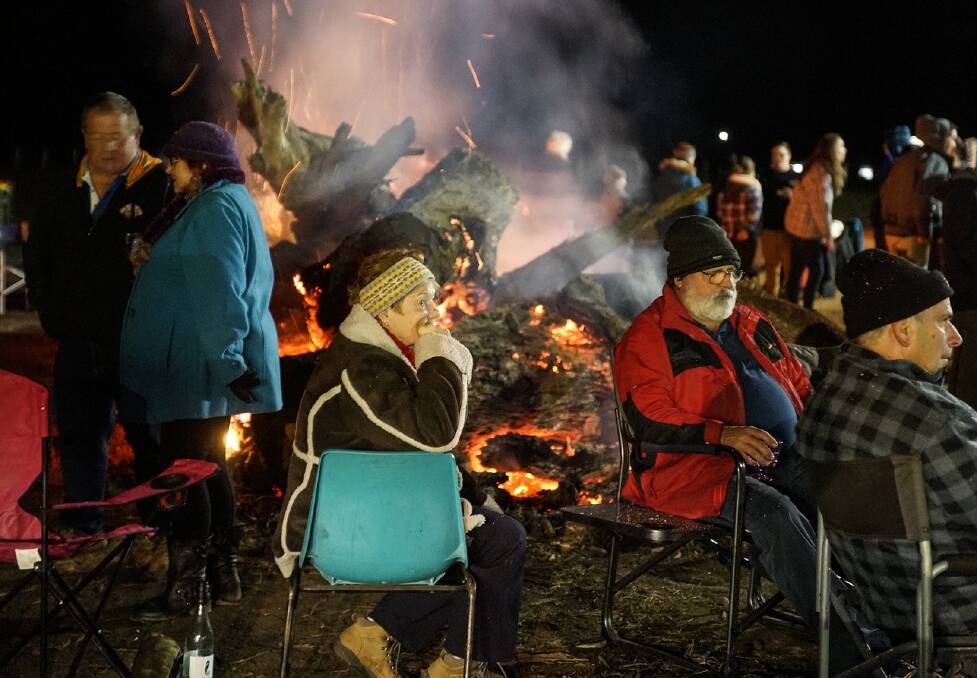 Attendees enjoying the bonfire. Photo: Paul Anderson. 