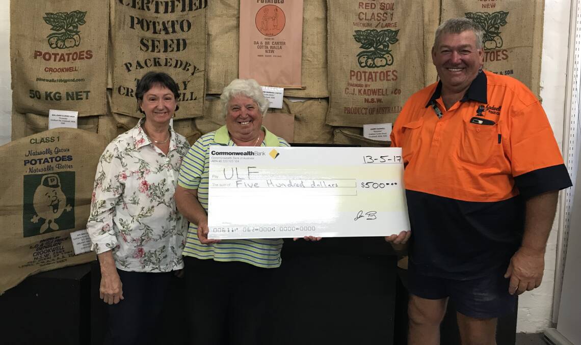 Marg Anderson, Jan Pont presenting cheque to Garry Kadwell, President ULF at the Crookwell Visitor Information Centre. Photo: Liz Gorman. 