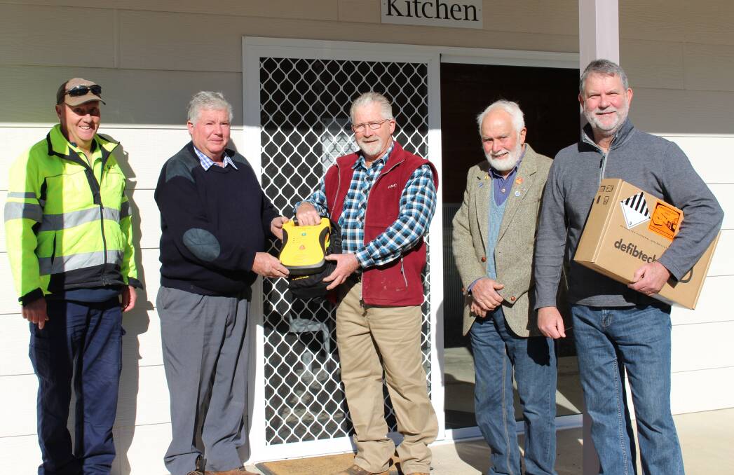 DONATION: The Crookwell Caravan Park accepting the defibrillator. Photo: supplied.
