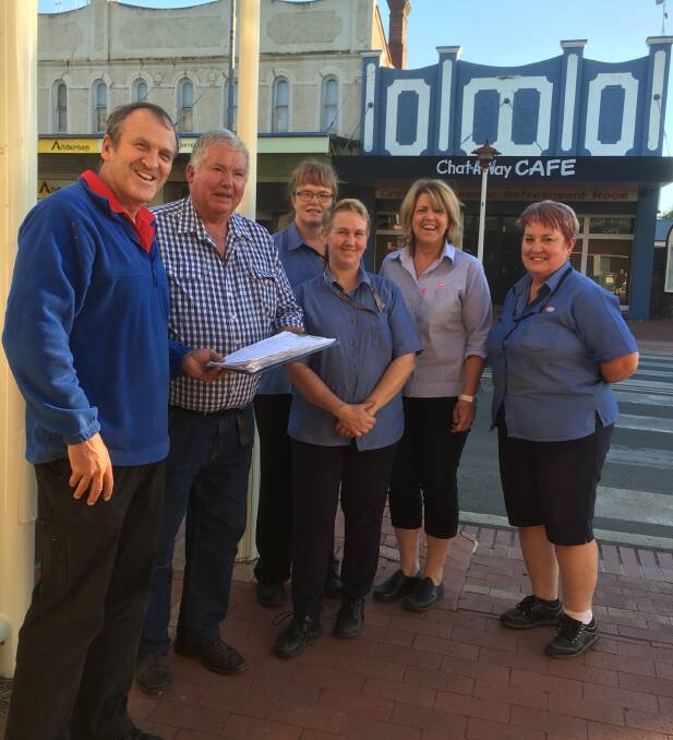 Crookwell IGA staff handing over the petition to Upper Lachlan Shire Council mayor Brian McCormack. 