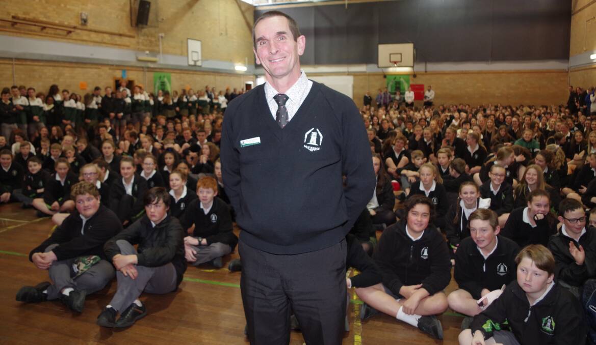 HONOURED: Mulwaree High deputy principal Russell Lieschke standing in front of the stucents and staff assembled in the hall after the announcement to the school of him receiving the NSW Public Education Secretary's Award. Photo: Darryl Fernance