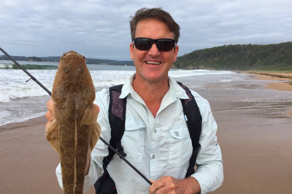 TV VIEWING ON SUNDAY: Fishing Australia host Rob Paxevanos with a nice  flathead caught at one of the Eurobodalla Shire beaches. Photo: Supplied by Rob Paxevanos