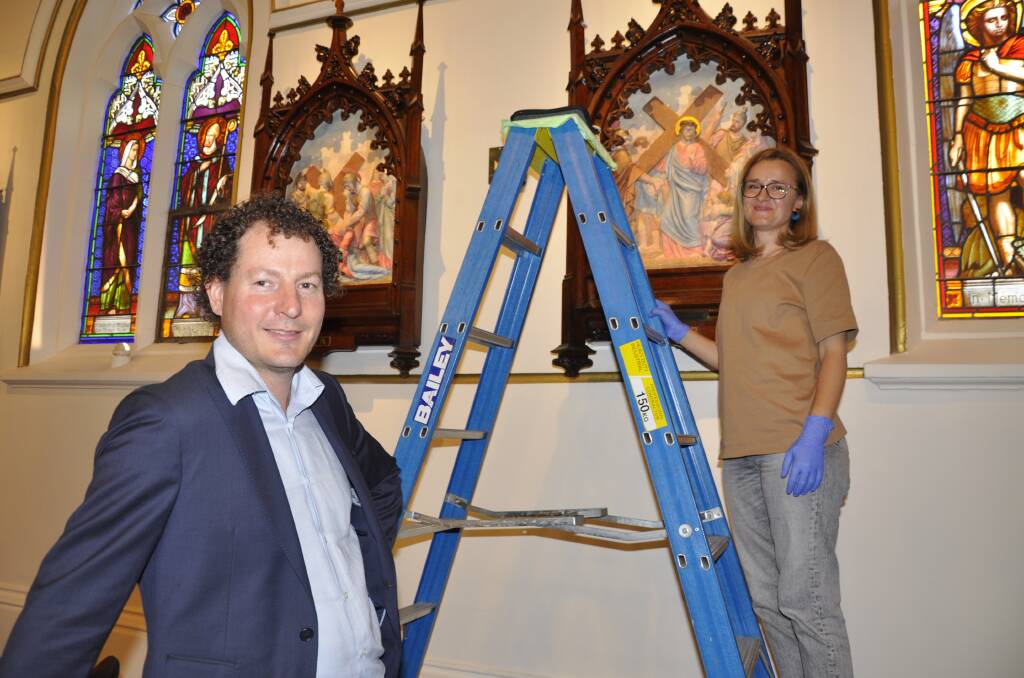 Former Goulburn man and cathedral parishioner, Adam Godijn and senior conservator, Alis Jitarescu restored the Stations of the Cross with their team at International Conservation Services.