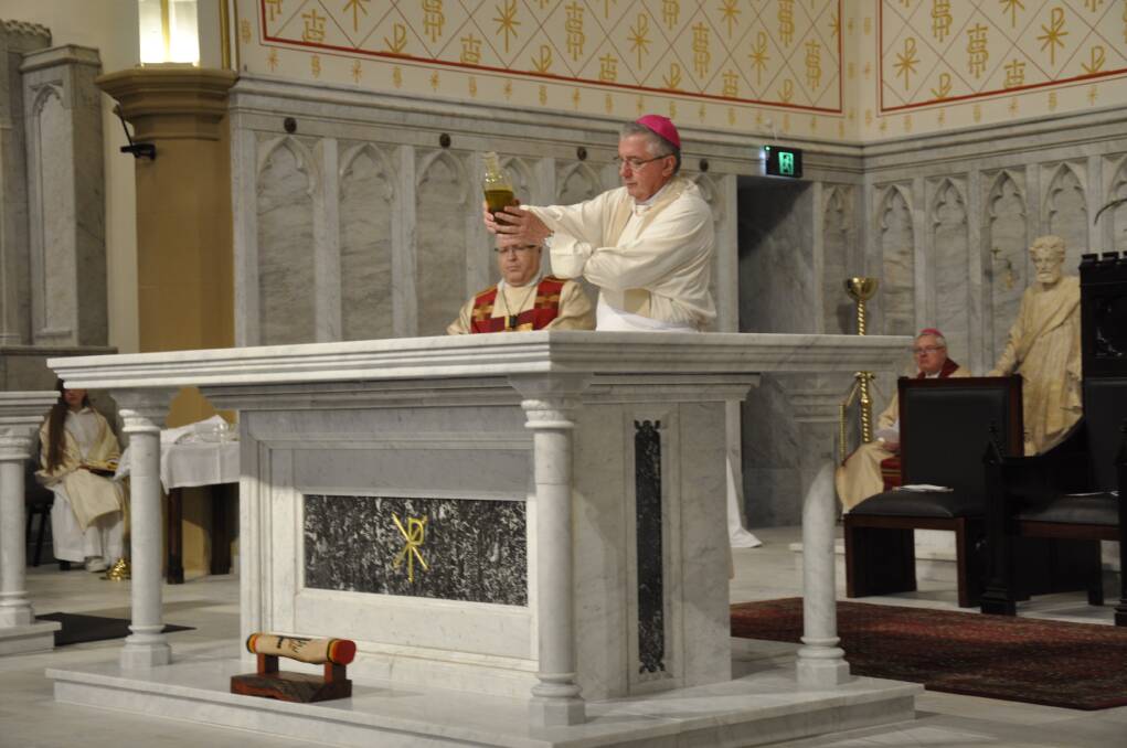 Archbishop Prowse anoints the mensa altar. Picture by Louise Thrower.