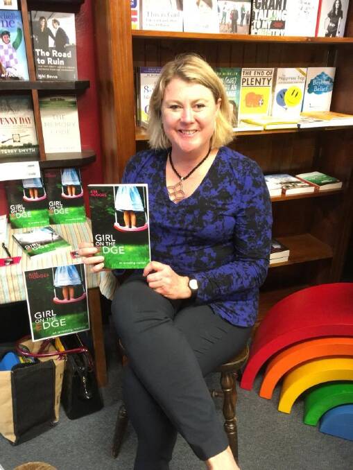 Author Kim Hodges with her book 'A Girl on the Edge'.   