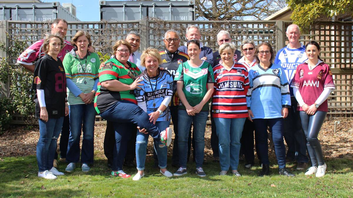 BOOTS AND ALL: Staff at Upper Lachlan Shire Council joined in Footy Colours Day this week to raise money for the Fight Cancer Foundation. Photo Bronwyn Haynes.
