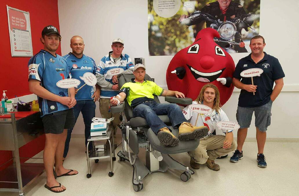 Dogs' donors: Sam Elliot, Charlie Zouch, James Croker, Aaron Leighton, Logan Boyd and Fred Bensley with the Blood Service mascot.
