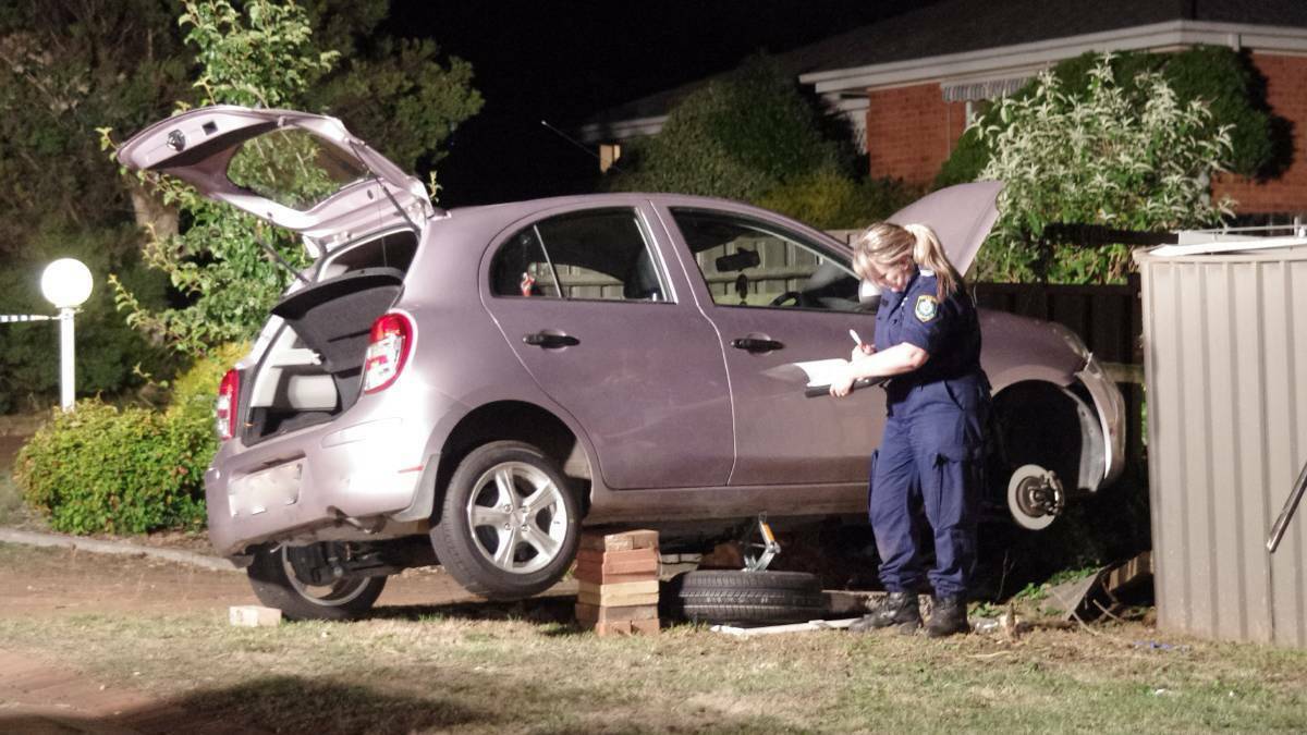 EXAMINING: Forensic officer Sergeant Nicole Brown examines the car underwhich the man had been trapped in 2016. Photo: Darryl Fernance