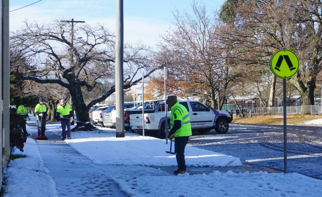 The Upper Lachlan Shire Council's crews clear up paths after several centimetres of snow fell on the area. Photo: Clare McCabe.