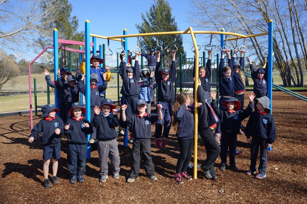 PLAY TIME: Taralga Primary School students dig the upgraded playground at the town's Goodhew Park. Photo: Clare McCabe.