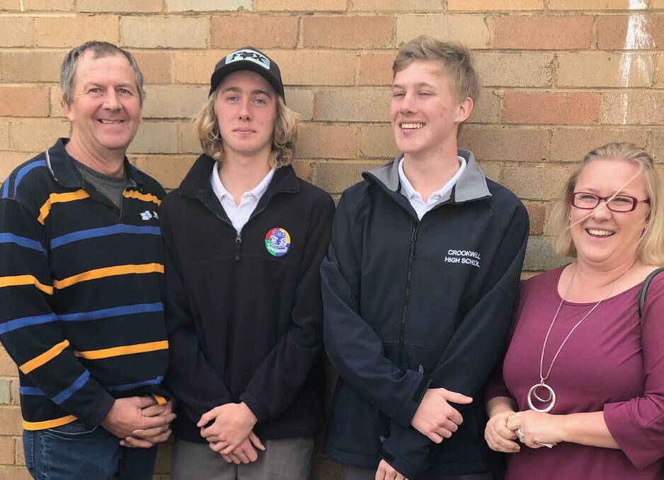 Think pink:Rebecca George (right) pictured with her family, David, Riley and Zach, is encouraging the town to support turning pink for October. Photo supplied