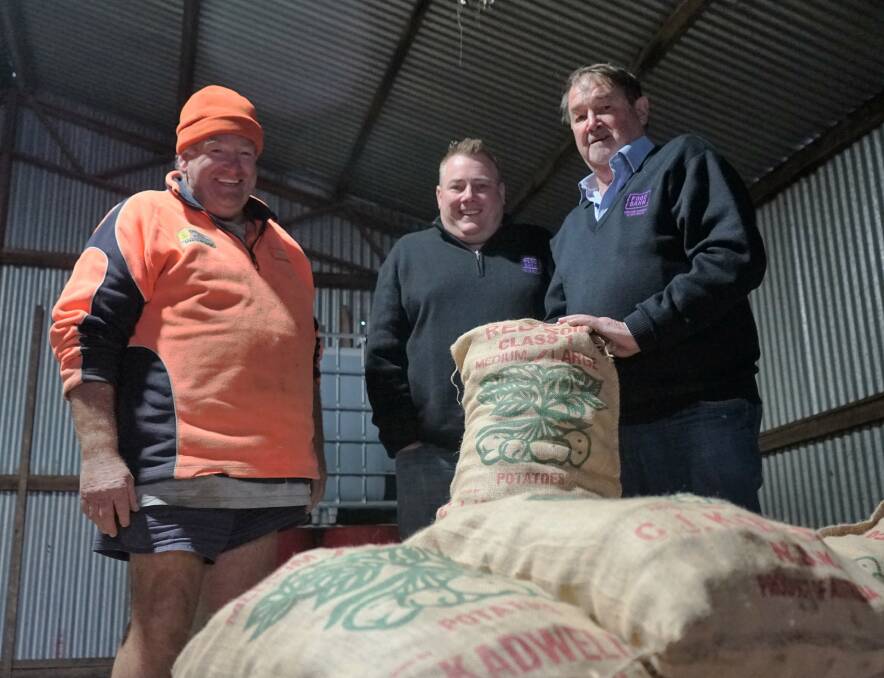 Feeding Australians: Garry Kadwell with Ben Cox and Ian Cox of Foodbank. Photo: Clare McCabe.
