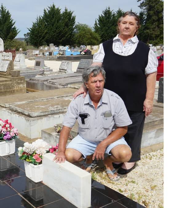 Kim and Ann Cahalan at the resting site of forebear Staff Sergeant Thomas Cahalan, whose grave site has been vandalised four times this year.