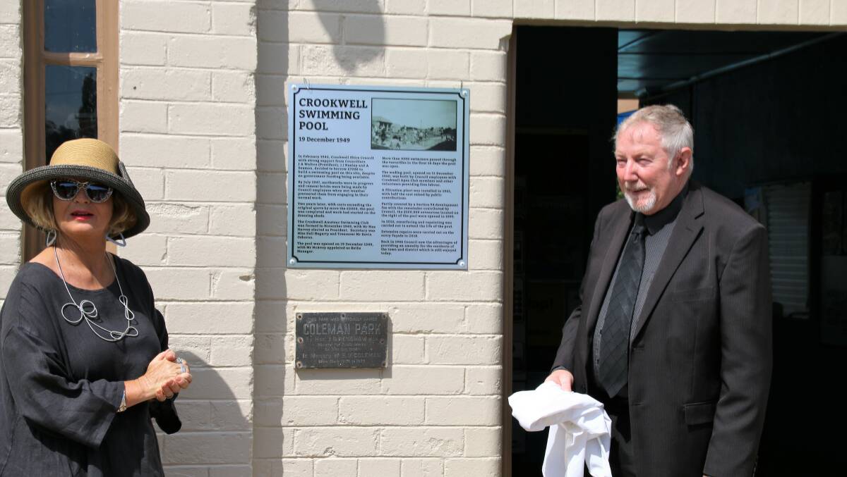 Councillor Pam Kensit and John Searl unveil the historical information board at the Crookwell swimming pool. Photo supplied. 