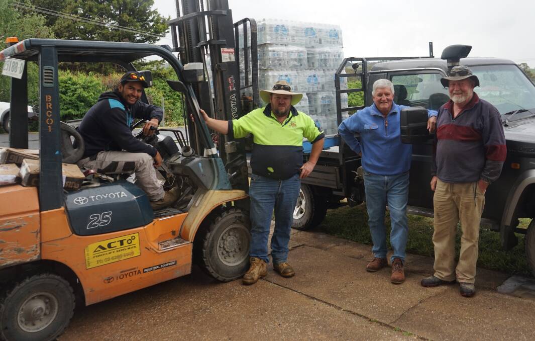 Relief for Trundle: Dion Aramoana from JD'S Hardware and Rural Supplies loads a pallet of water for Leigh Sharwood, Les Hall and Gavin McDonald to deliver to Trundle. Photo: Clare McCabe