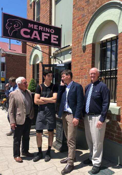 Signal boost: Gunning benefits from the installation of a 4G Telstra small cell, (L-R) Angus Taylor, John Stafford,John Bell and Merino Café staff member Chris Young. Photo supplied. 