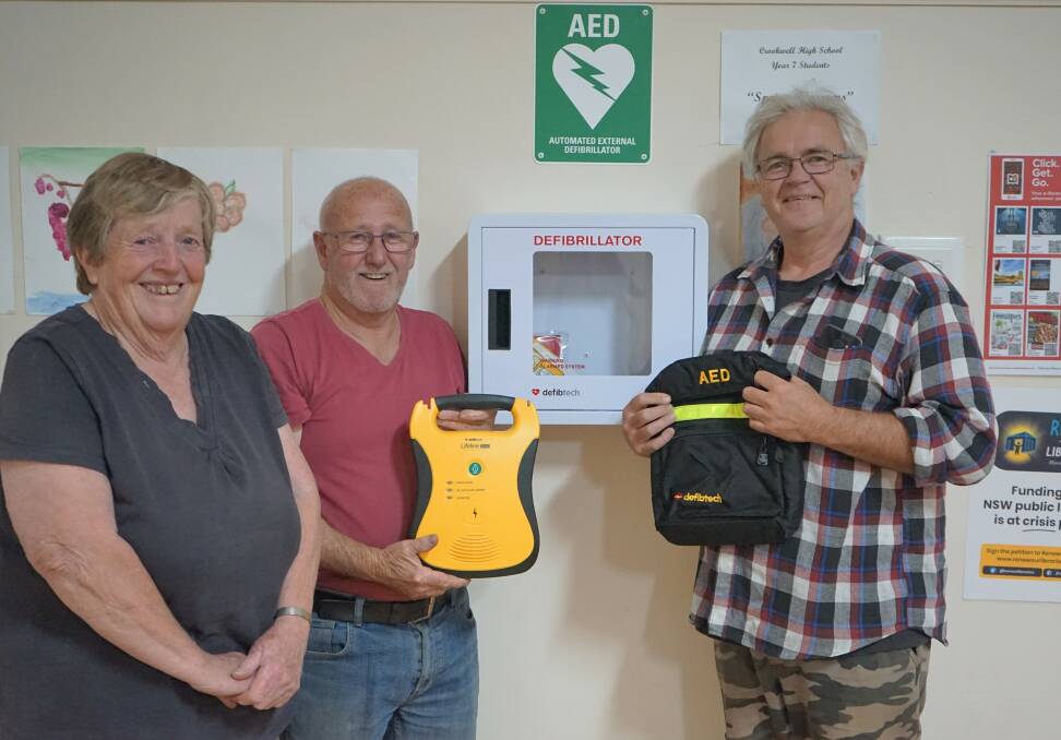Health: Jenny Painter, Robert Bill and Dallas Atkins and the Memorial Hall Committee install a life-saving AED. Photo: Clare McCabe