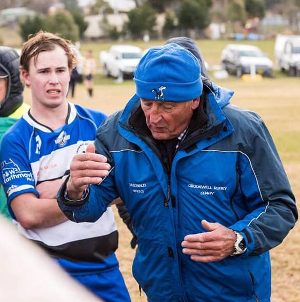 Rugby Union: Coach Bruce Nixon talks to his team at half-time of the major semi-final against the Taralga Tigers. Photo: Crookwell Dogs Rugby Club Facebook.