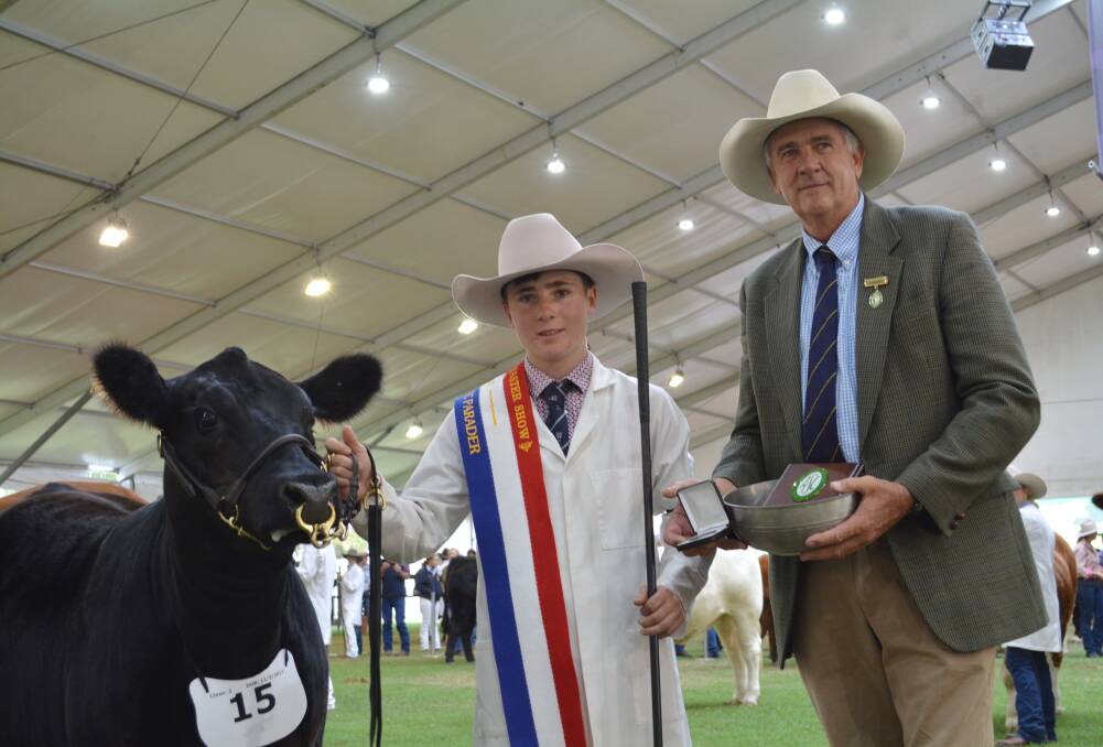 TRIUMPH: George Harborne after winning NSW grand champion state parader with vice president of the ASC, Tim Capp.