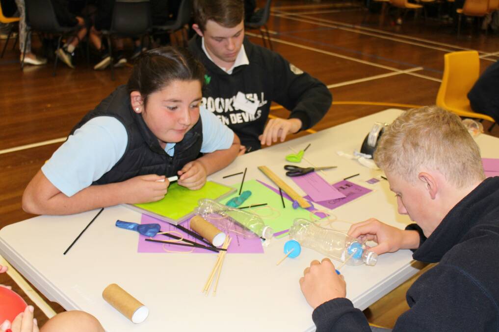 STEM excellence: Students working together to build a balloon powered car. Photo supplied.