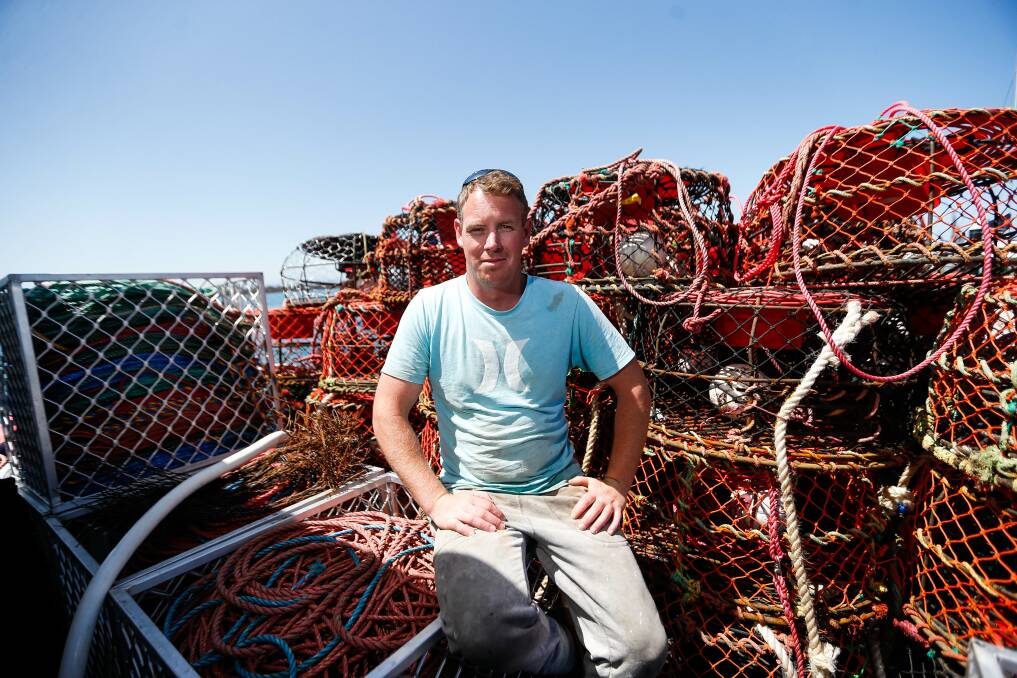 DOWNED TOOLS: Portland rock lobster fisher Callum McCarthy with empty cray pots after factories stopped buying catches due to cancelled orders. Picture: Anthony Brady
